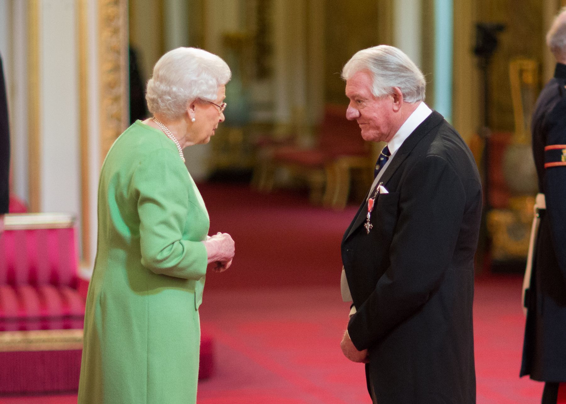 Angus receiving MBE from Queen Elizabeth II credit - Image courtesy of British Ceremonial Arts Limited.